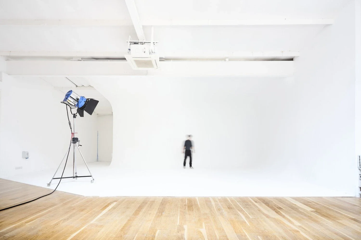 Studio 1's expansive white photographic cove beneath exposed roof trusses